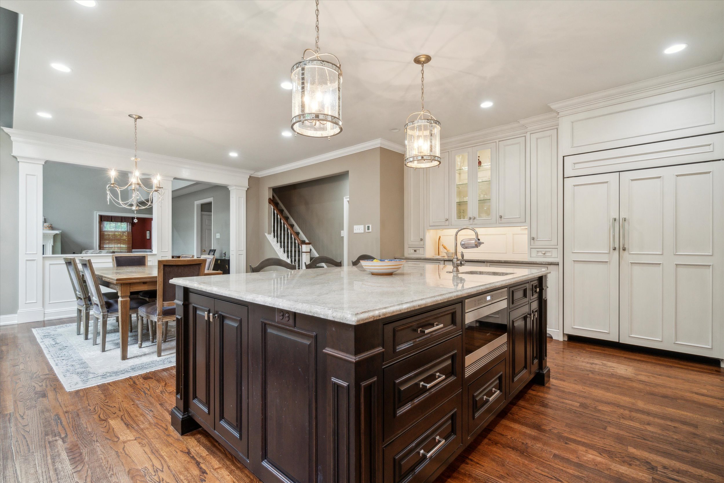 145 Biddulph Road Wayne, PA 19087 - Photo 6 of 39 a kitchen with granite countertop a table chairs stove a refrigerator and a fireplace