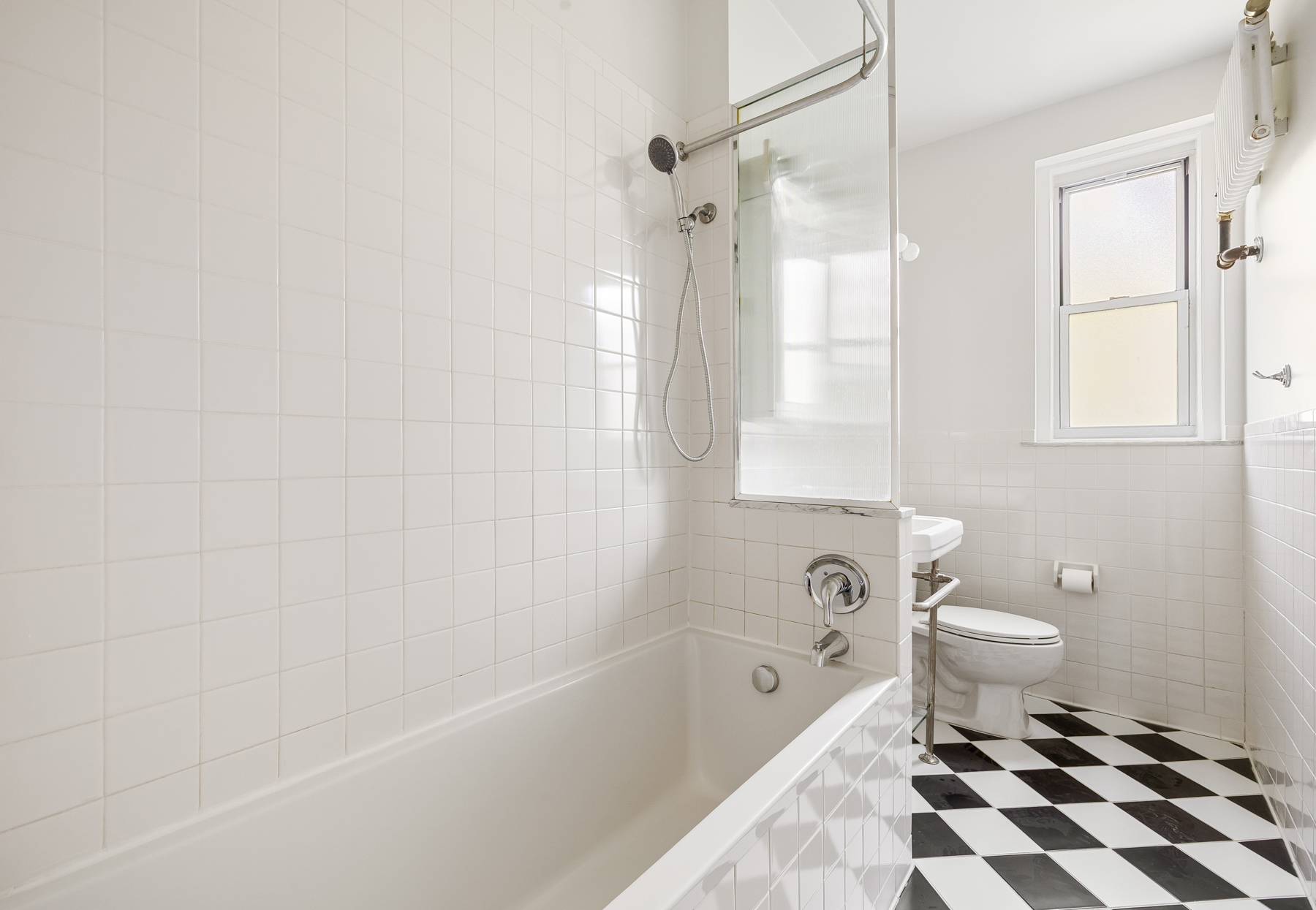 35-27 76th Street, Unit 21 Queens, NY 11372 - Photo 17 of 24 a bathroom with a bathtub and a toilet