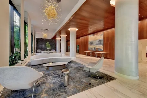 a lobby with furniture and flat screen tv