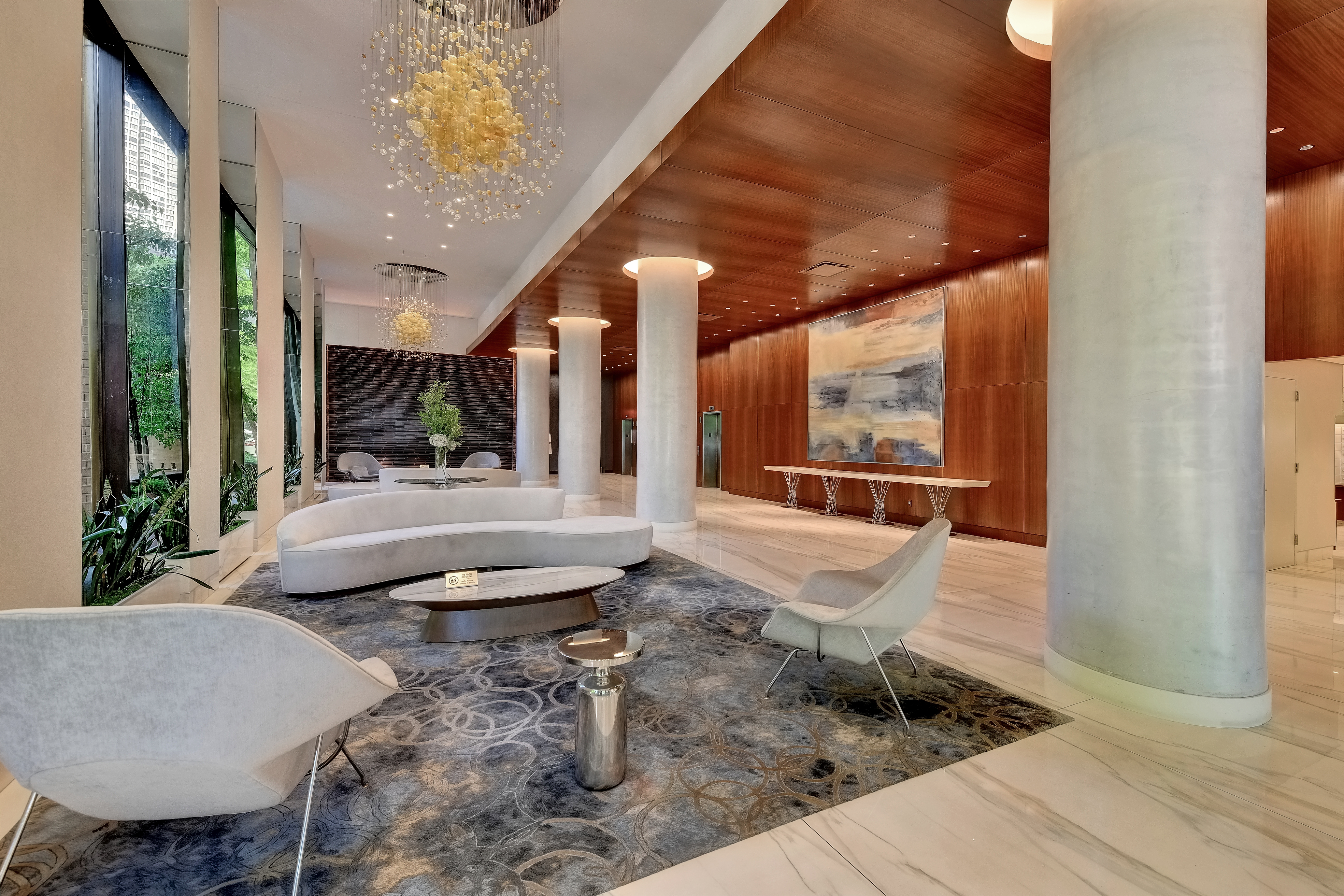 630 1st Avenue, Unit 34B Manhattan, NY 10016 - Photo 4 of 8 a lobby with furniture and flat screen tv