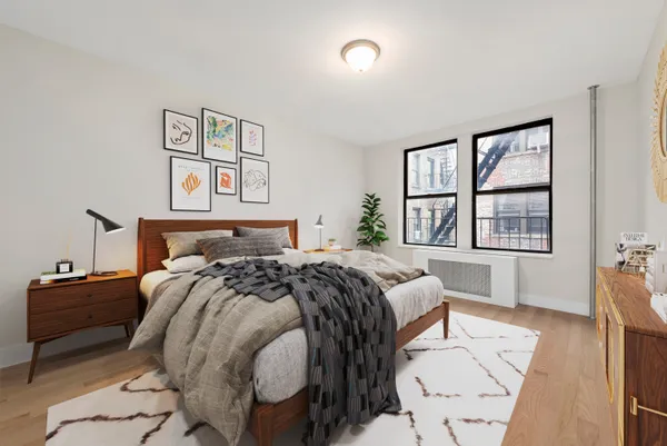 a bed sitting in a bedroom next to a window