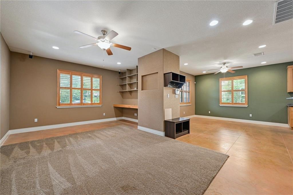 1102 Clermont Avenue Austin, TX 78702 - Photo 2 of 30 an empty room with windows and ceiling fan