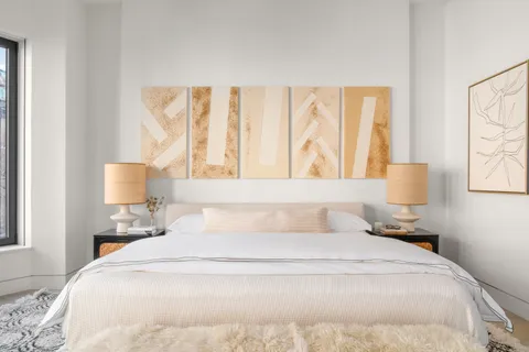 a bedroom with a bed and a lamp with window