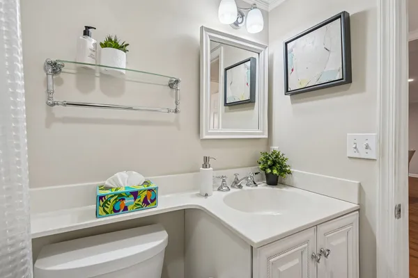 a bathroom with a sink mirror and vanity