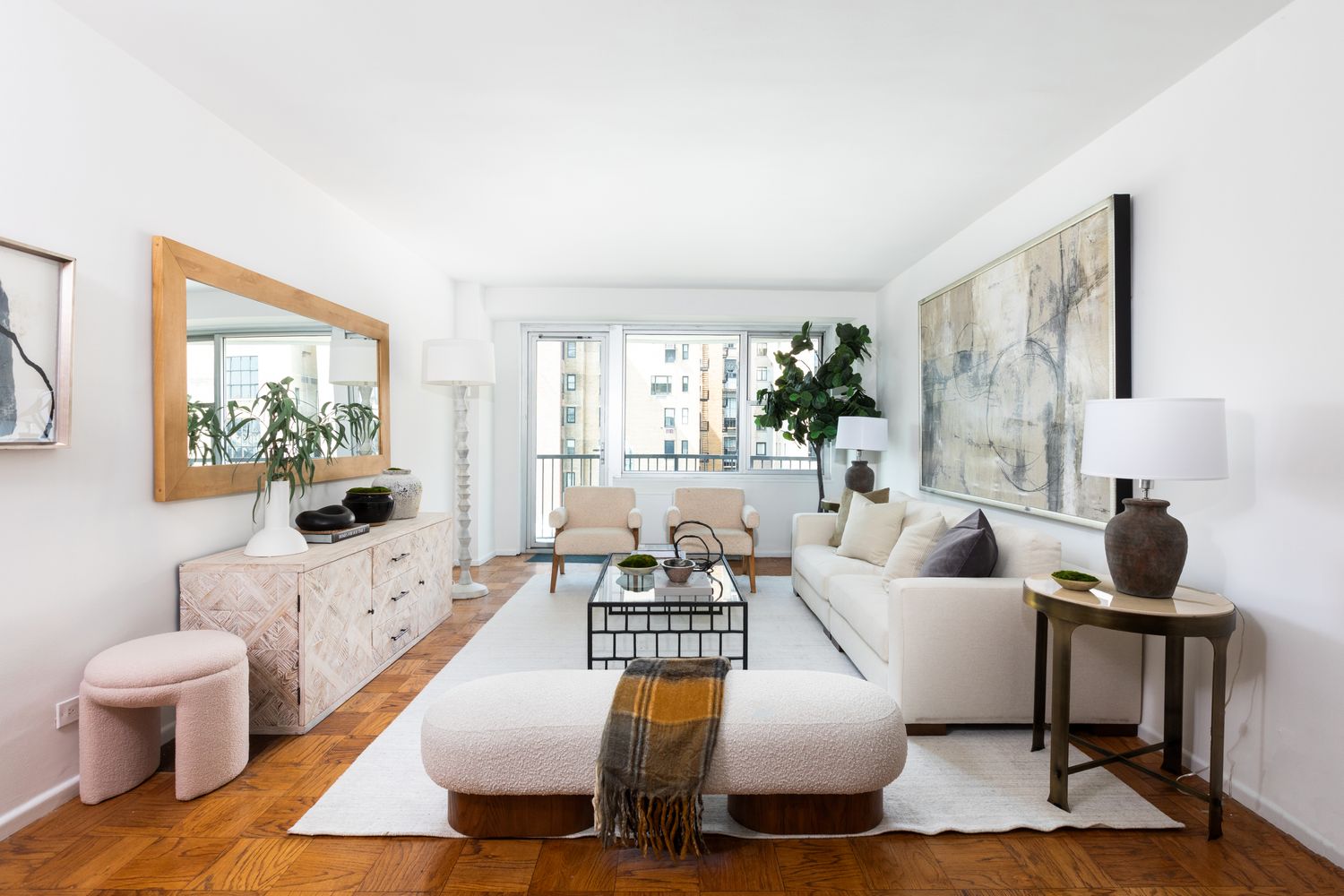 a living room with fireplace furniture and a large window