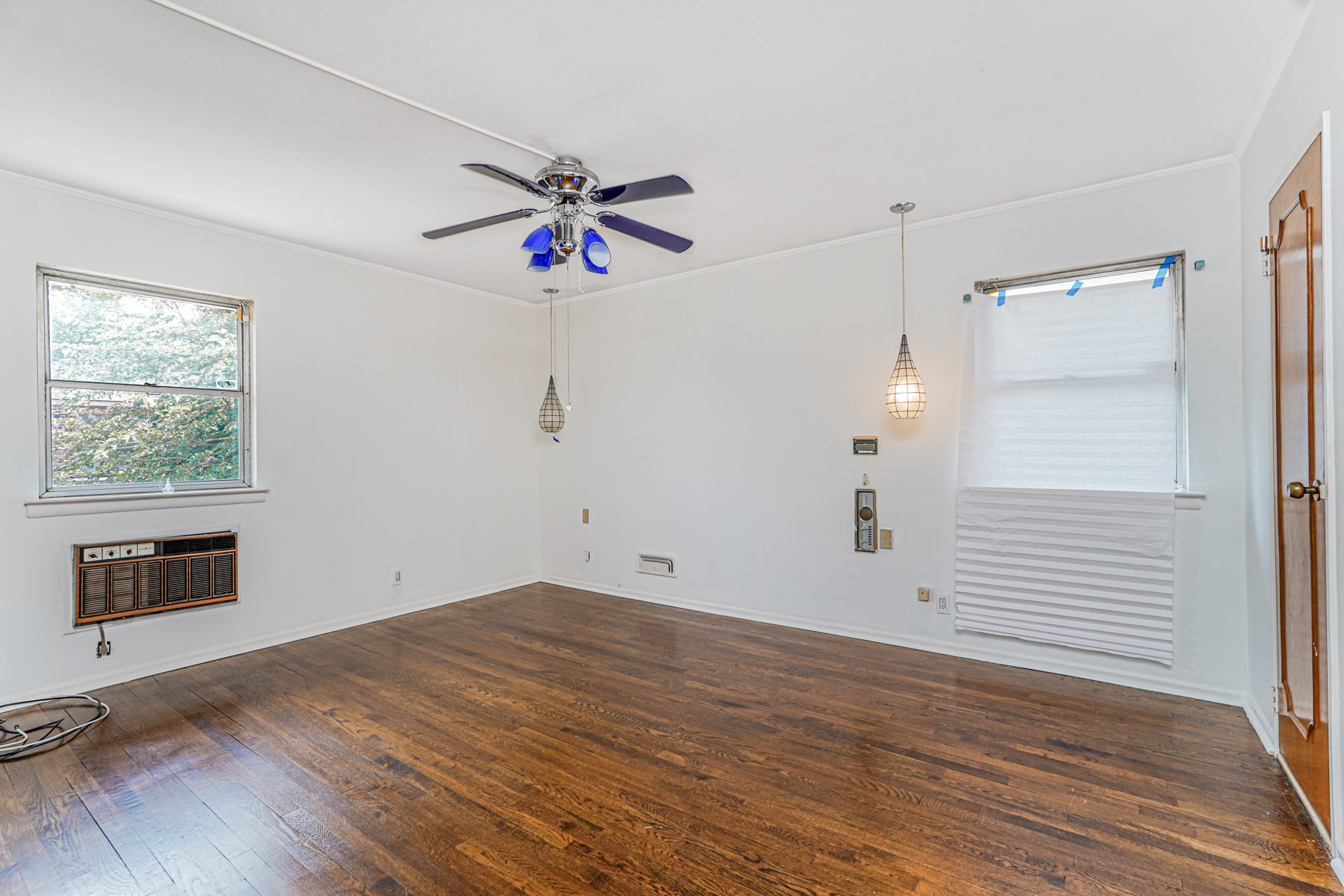 461 Mayfair Drive South Brooklyn, NY 11234 - Photo 10 of 30 an empty room with wooden floor a ceiling fan and windows