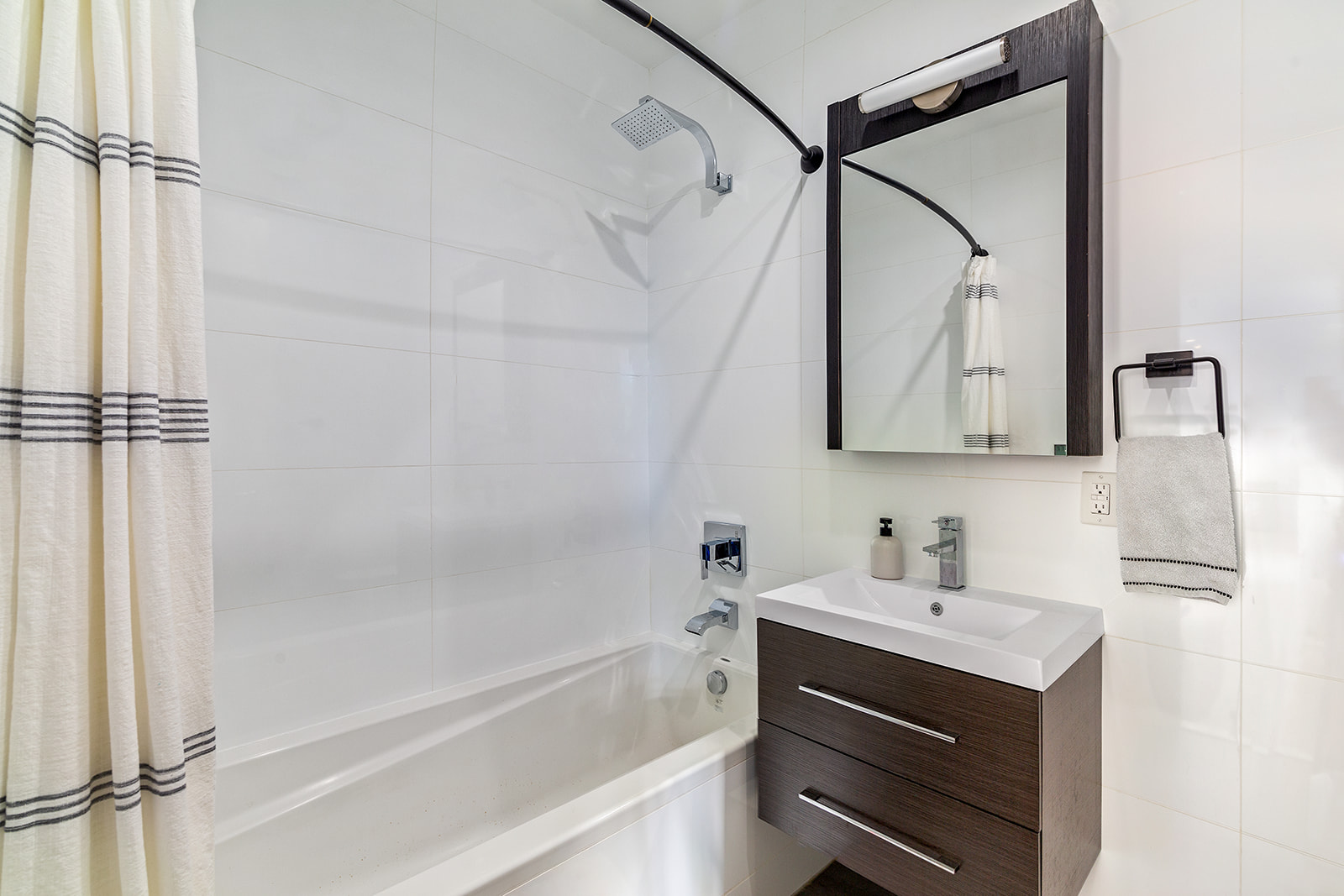 695 6th Avenue, Unit 2L Brooklyn, NY 11215 - Photo 8 of 10 a bathroom with a sink vanity tub and shower