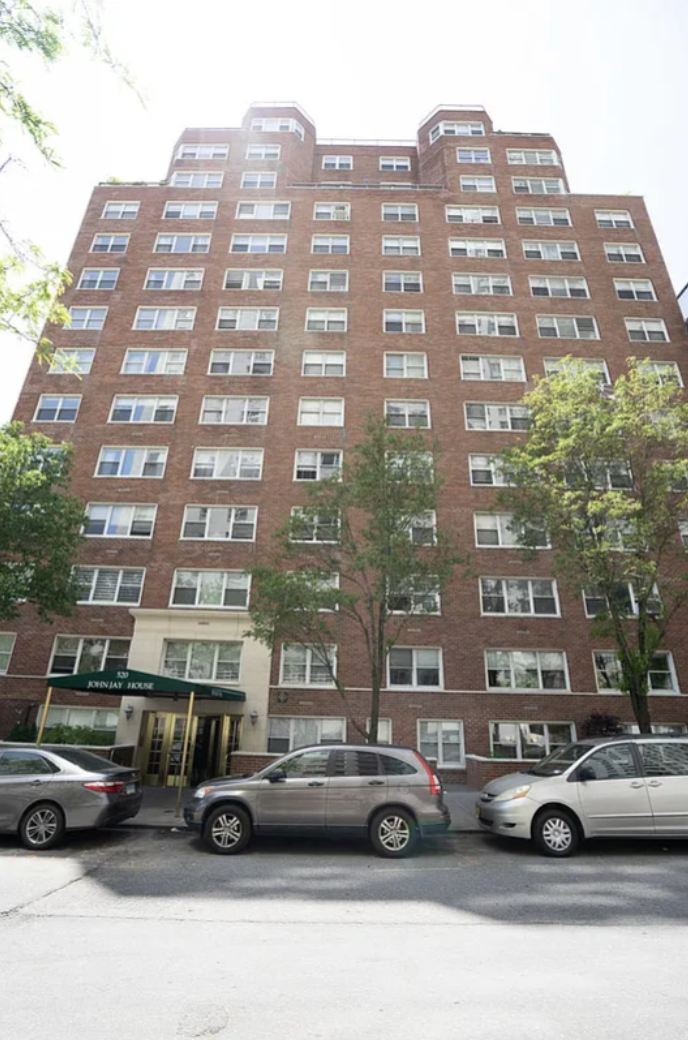 520 East 76th Street, Unit 11C Manhattan, NY 10021 - Photo 11 of 15 a front view of a residential apartment building with a cars parked