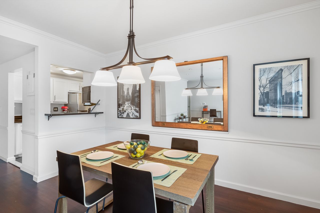 55 Poplar Street, Unit 2C Brooklyn, NY 11201 - Photo 3 of 14 a dining room with furniture and a wooden floor