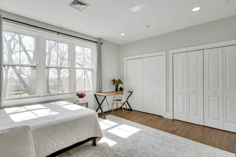 a bedroom with a bed and a window