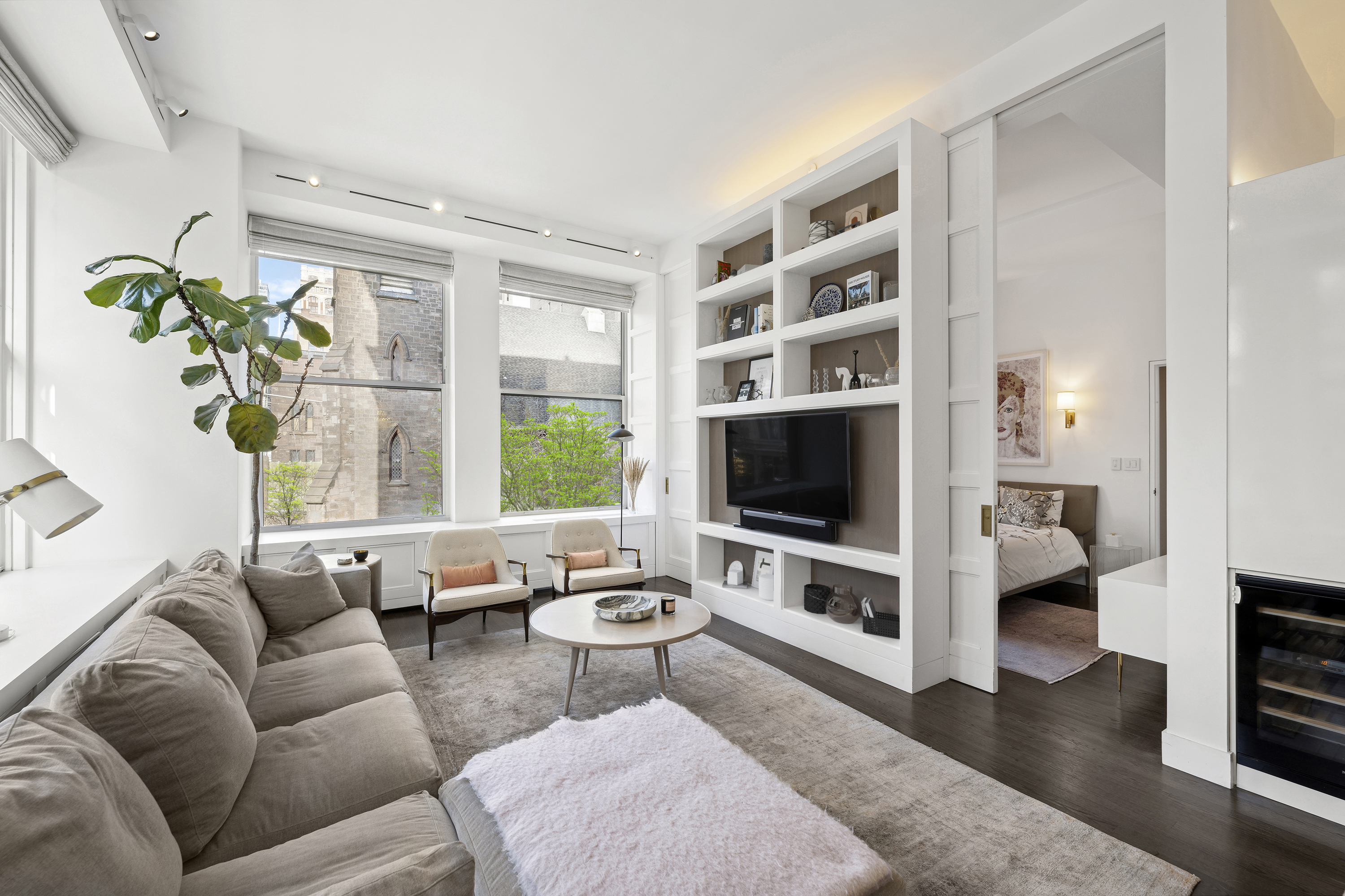 60 West 20th Street, Unit 2F Manhattan, NY 10011 - Photo 4 of 21 a living room with furniture flat screen tv and a large window