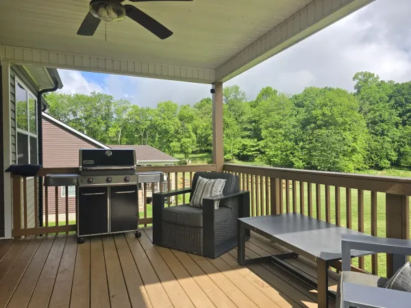 a view of balcony with wooden floor and outdoor seating