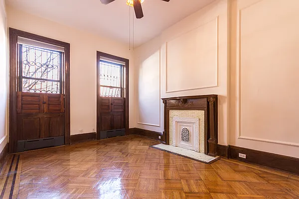 688 Saint Marks Avenue, Unit 1 Brooklyn, NY 11216 - Photo 8 of 10 a view of an empty room with window and fire place