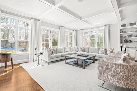 a living room with furniture and large windows