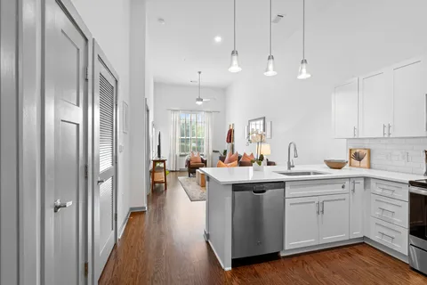 a kitchen with kitchen island a sink and a stove top oven