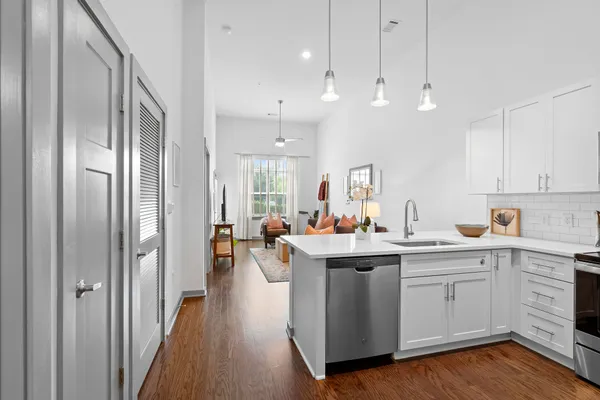 a kitchen with kitchen island a sink and a stove top oven