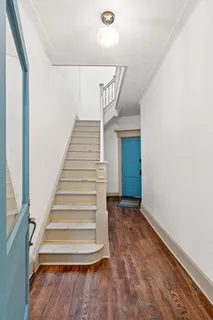 a view of entryway and hall with wooden floor
