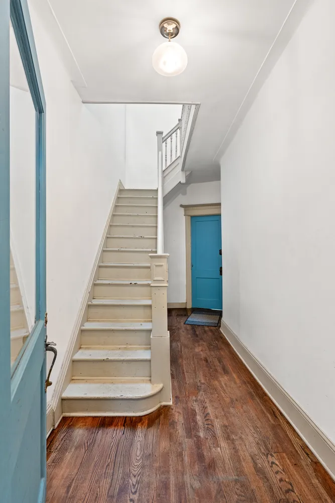a view of entryway and hall with wooden floor