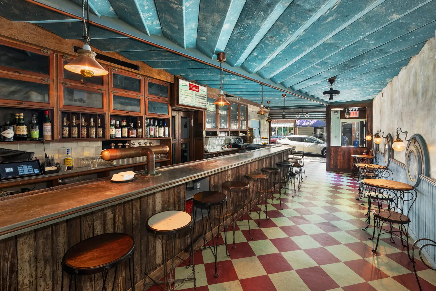 a kitchen with stainless steel appliances kitchen island granite countertop a table chairs and a view of living room