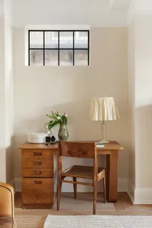a view of a bedroom with a bed and wooden floor