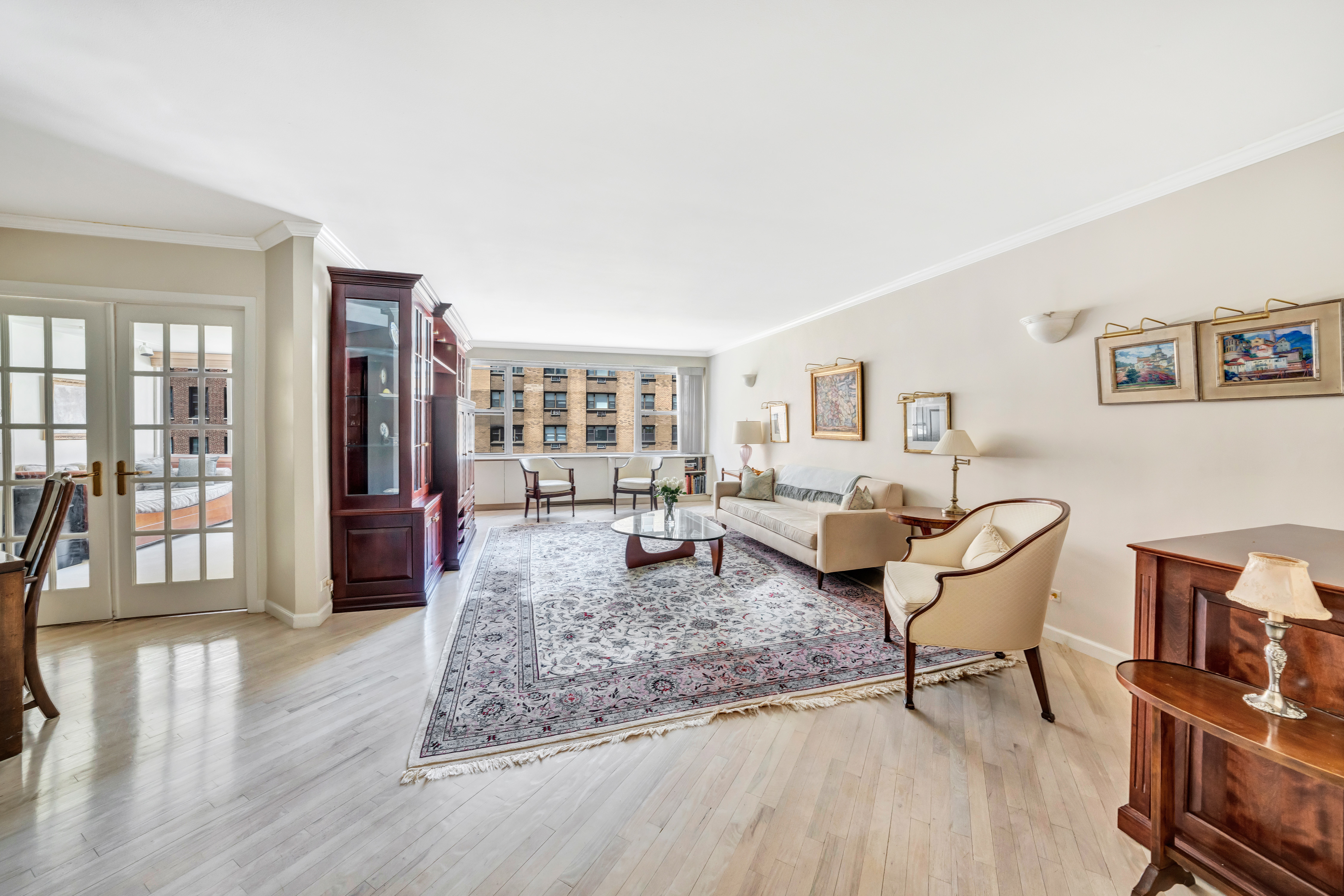 35 Sutton Place, Unit 7E Manhattan, NY 10022 - Photo 4 of 18 a living room with furniture and wooden floor