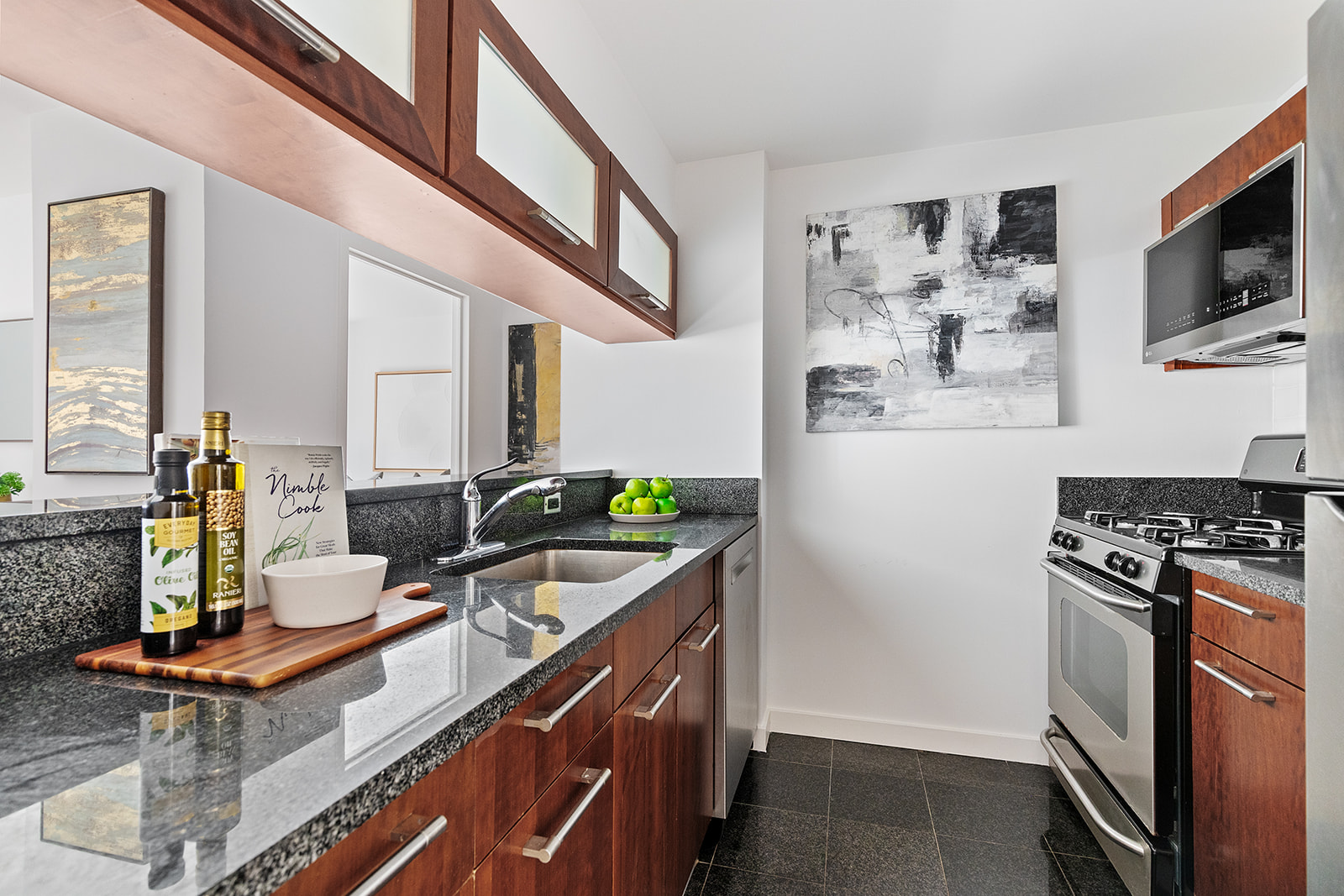 121 East 23rd Street, Unit 4H Manhattan, NY 10010 - Photo 2 of 12 a kitchen with stainless steel appliances a stove a sink and a refrigerator