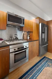 a kitchen with stainless steel appliances and wooden cabinets
