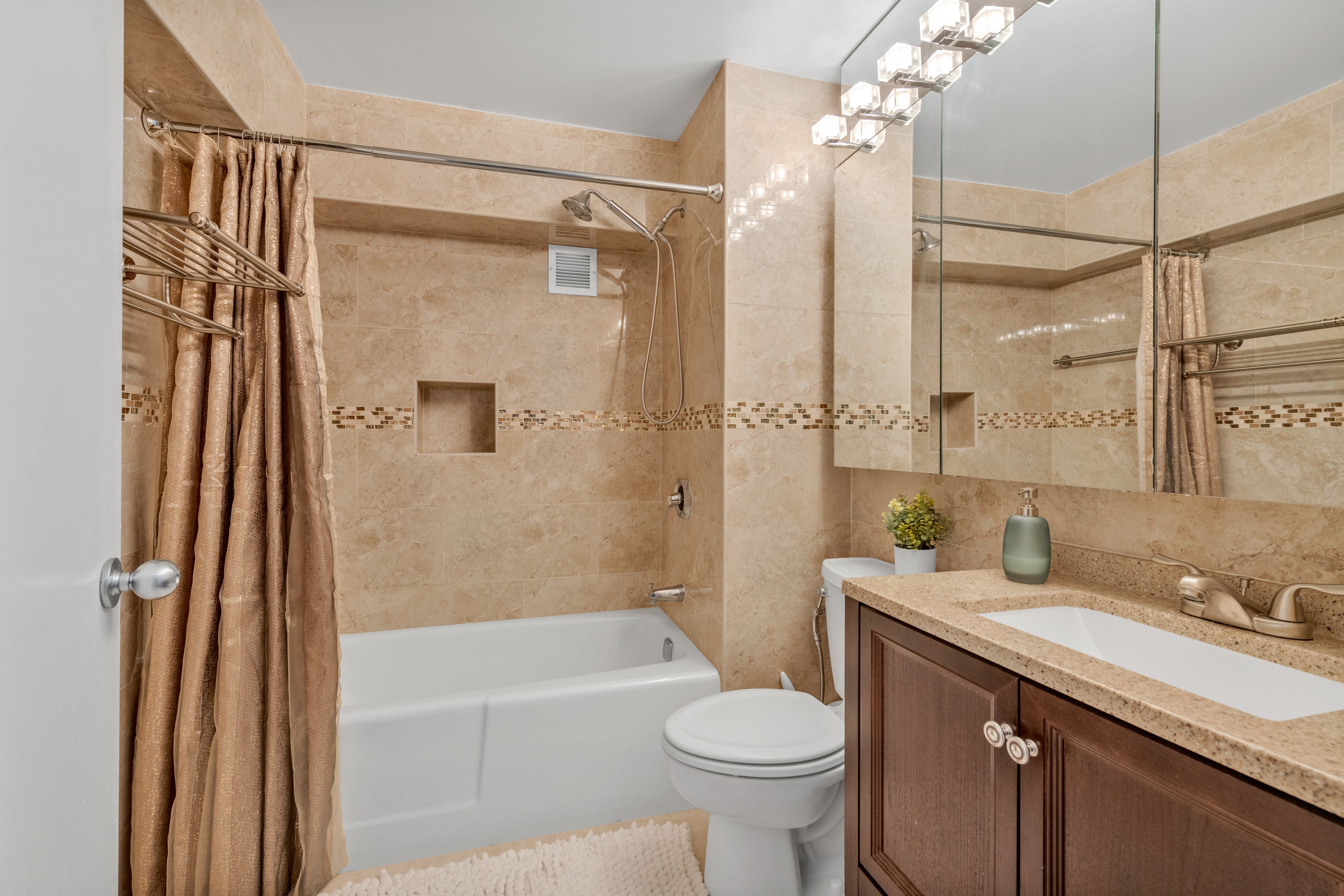 150 West 51st Street, Unit 1528 Manhattan, NY 10019 - Photo 5 of 21 a bathroom with a granite countertop sink toilet and shower