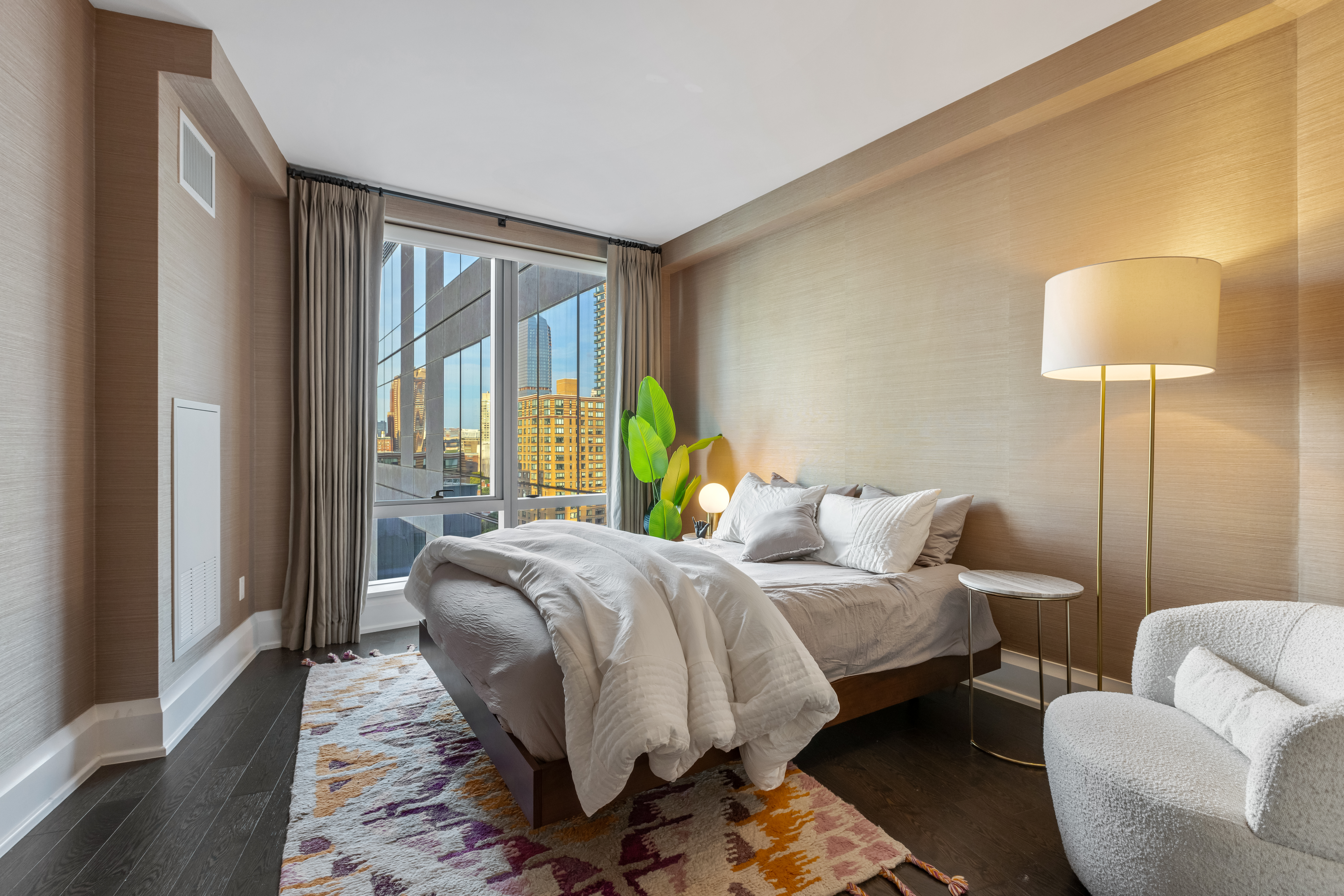 50 Riverside Boulevard, Unit 19F Manhattan, NY 10069 - Photo 10 of 24 a bedroom with bed and a large window