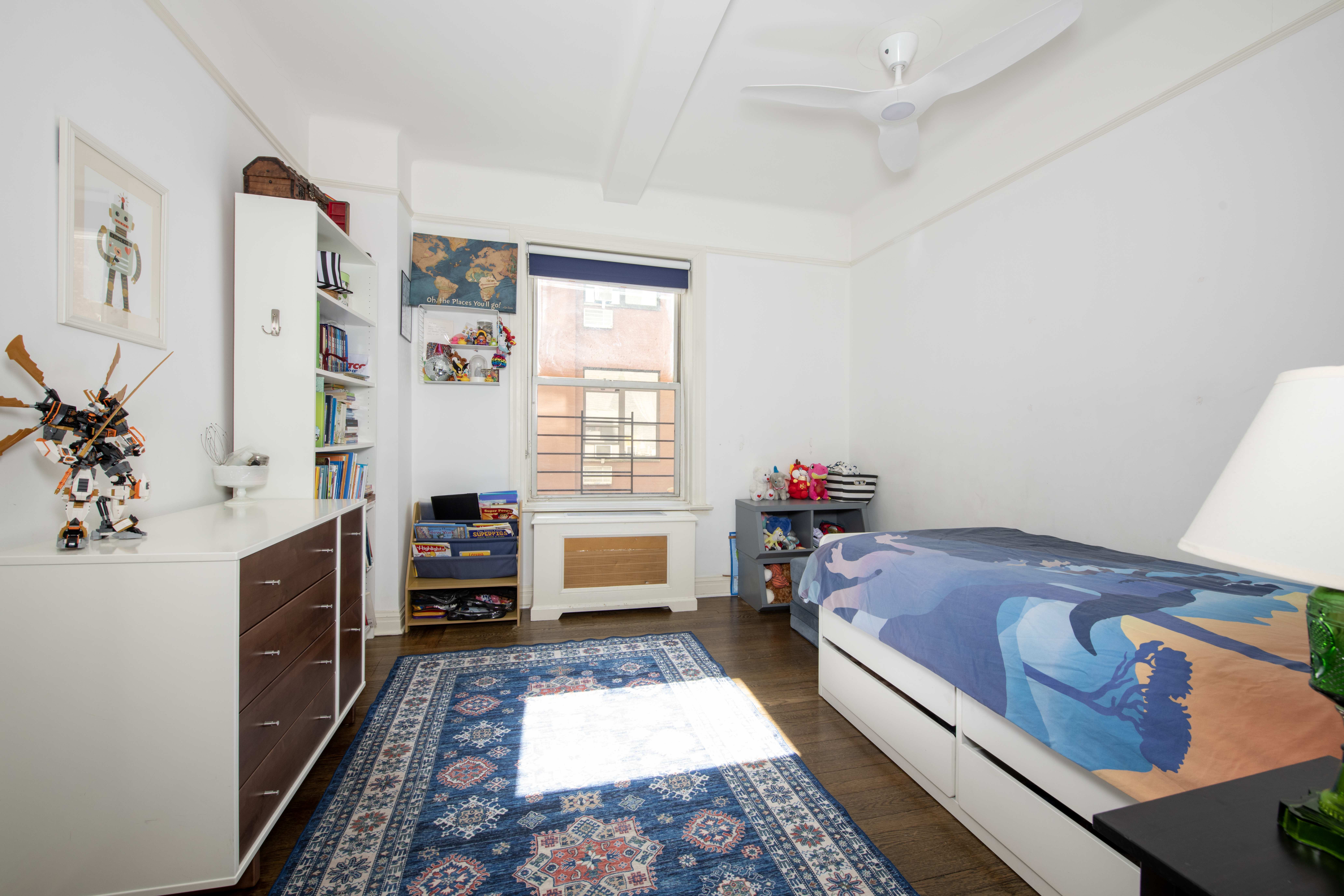 250 West 94th Street, Unit 3F Manhattan, NY 10025 - Photo 4 of 9 a bed room with a bed and a book shelf