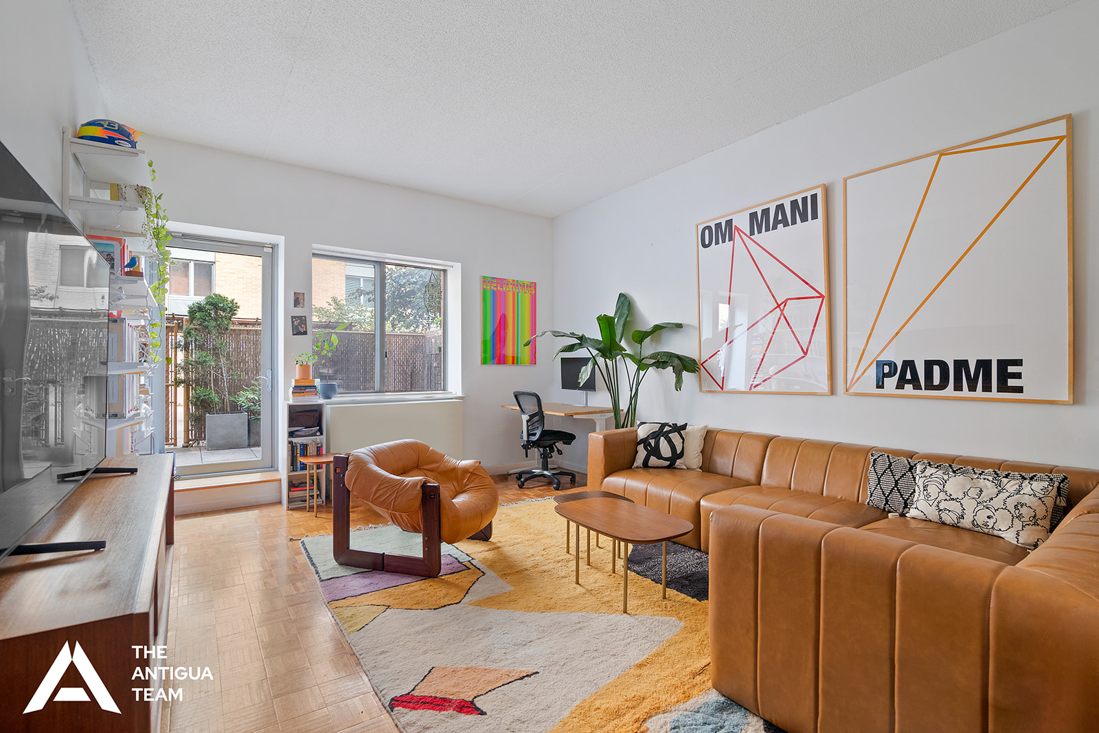 300 West 135th Street, Unit 2M Manhattan, NY 10030 - Photo 1 of 8 a living room with furniture and a potted plant