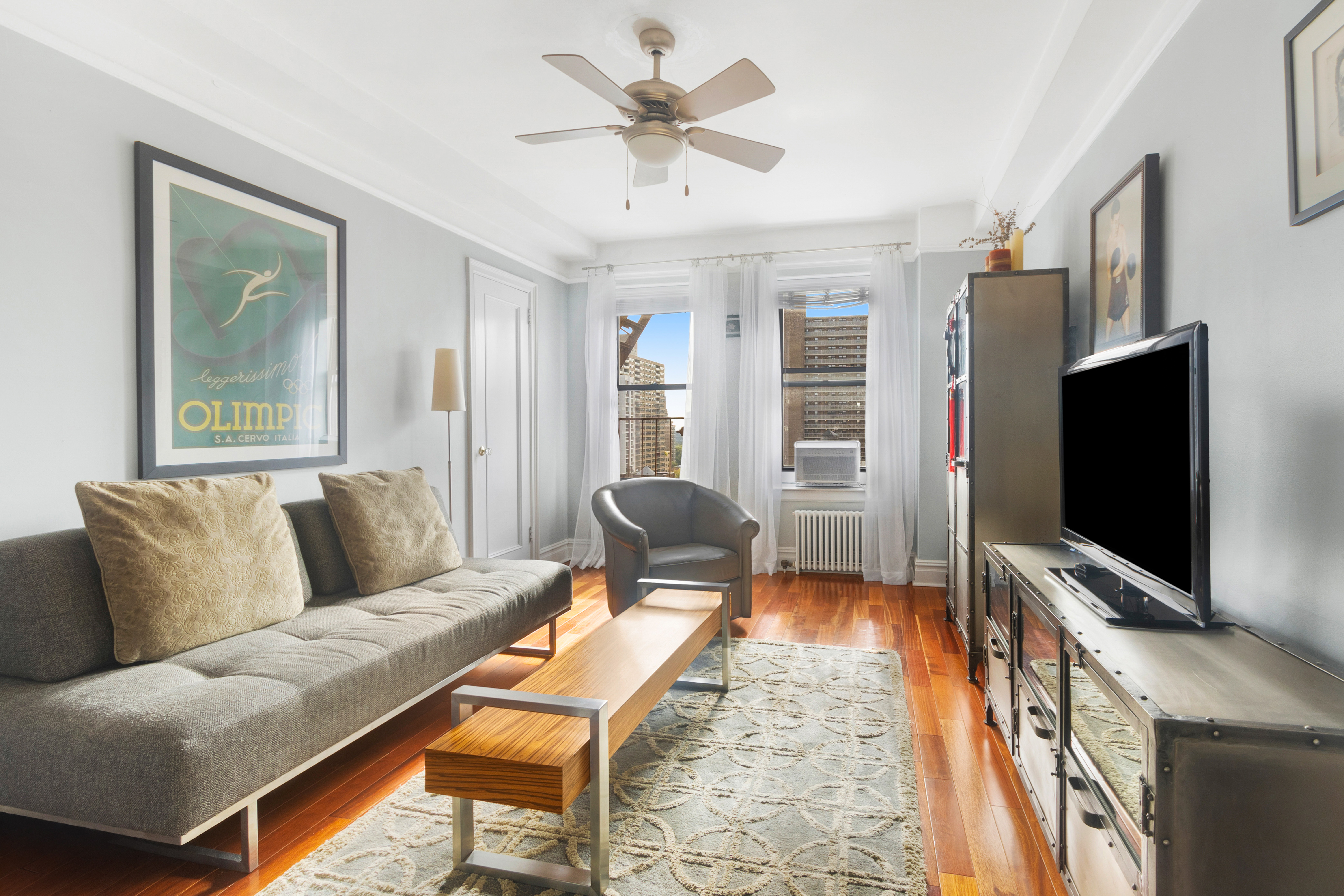175 West 93rd Street, Unit 17I Manhattan, NY 10025 - Photo 4 of 18 a living room with furniture and a flat screen tv
