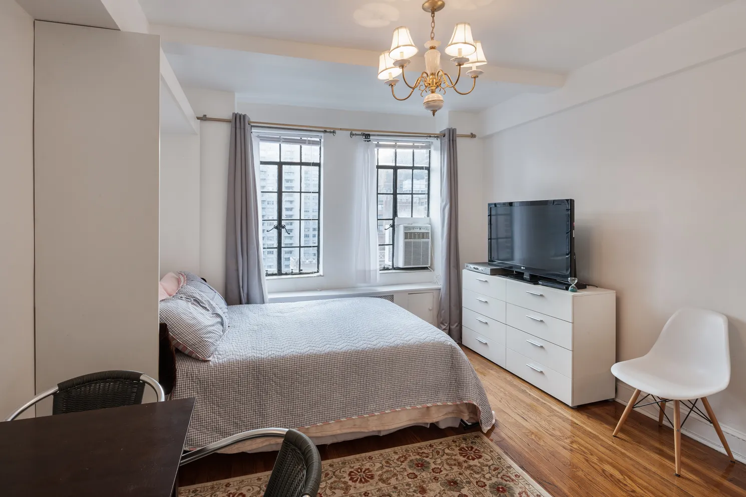 a bedroom with a bed and a flat screen tv