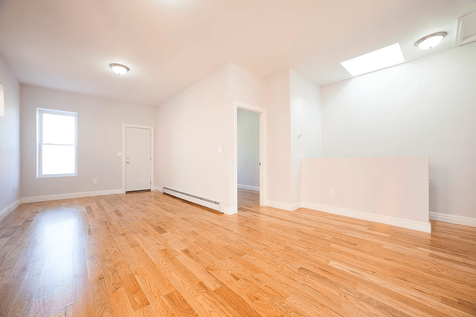 581 Van Siclen Avenue Brooklyn, NY 11207 - Photo 9 of 16 a view of an empty room with wooden floor and a window