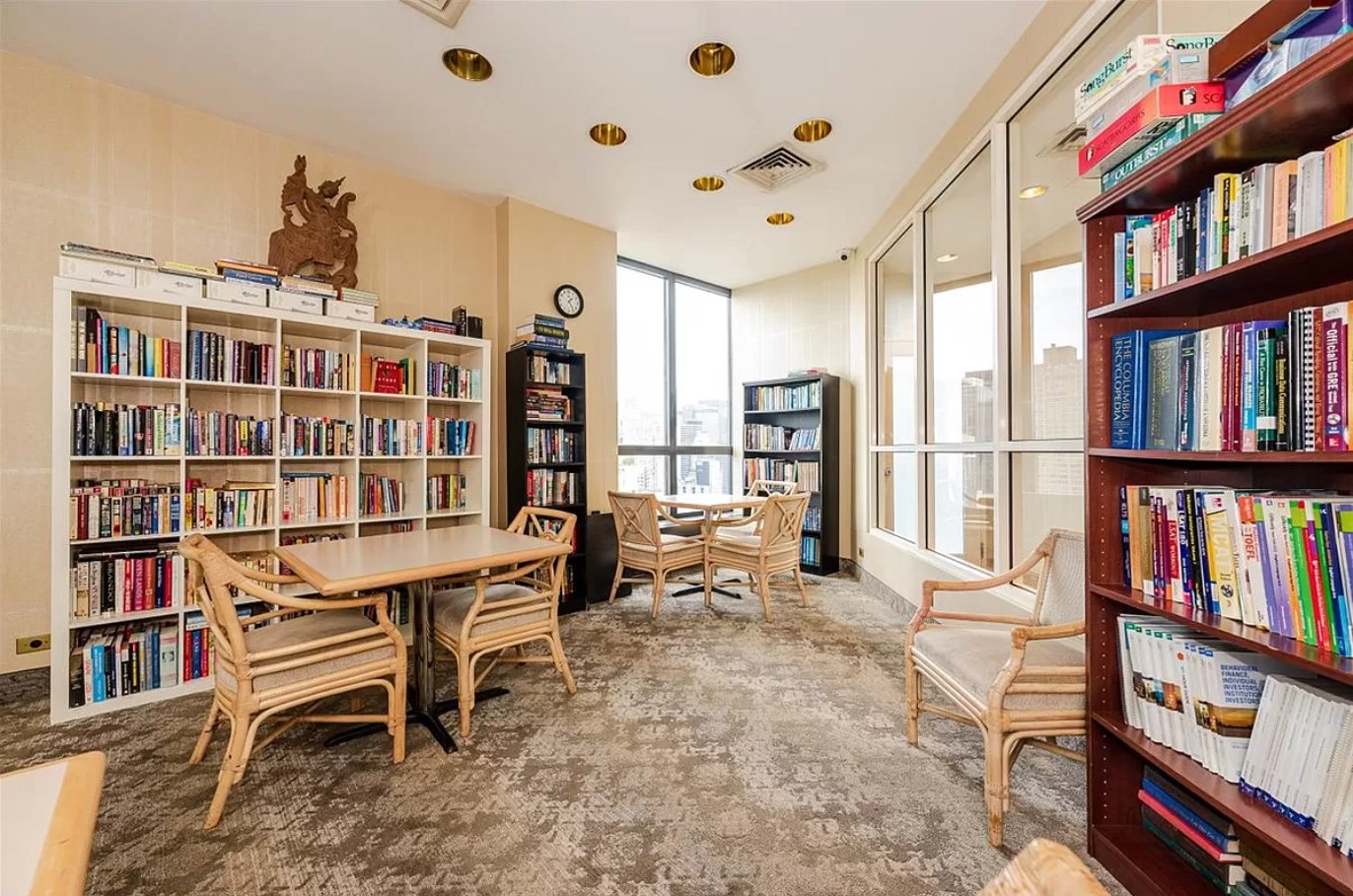 415 East 37th Street, Unit 32G Manhattan, NY 10016 - Photo 14 of 19 a view of a workspace with bookshelf