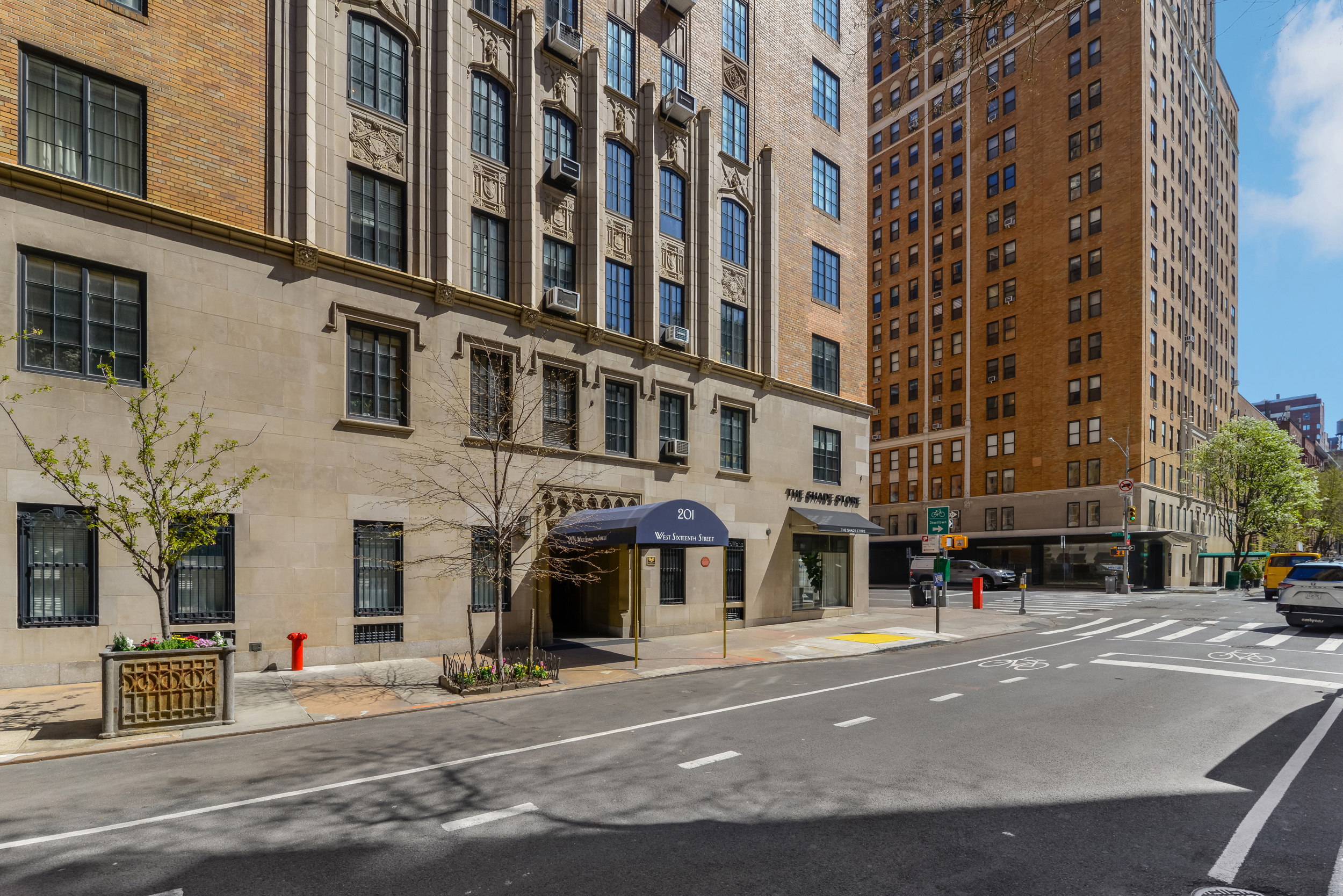 201 West 16th Street, Unit 3C Manhattan, NY 10011 - Photo 10 of 11 a city street lined with buildings and trees