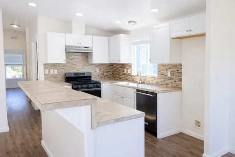 a kitchen with a stove a sink and a refrigerator
