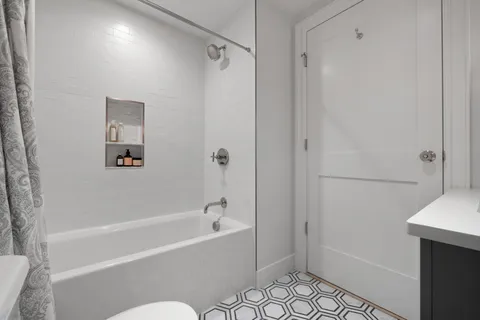 a bathroom with a bathtub and a shower