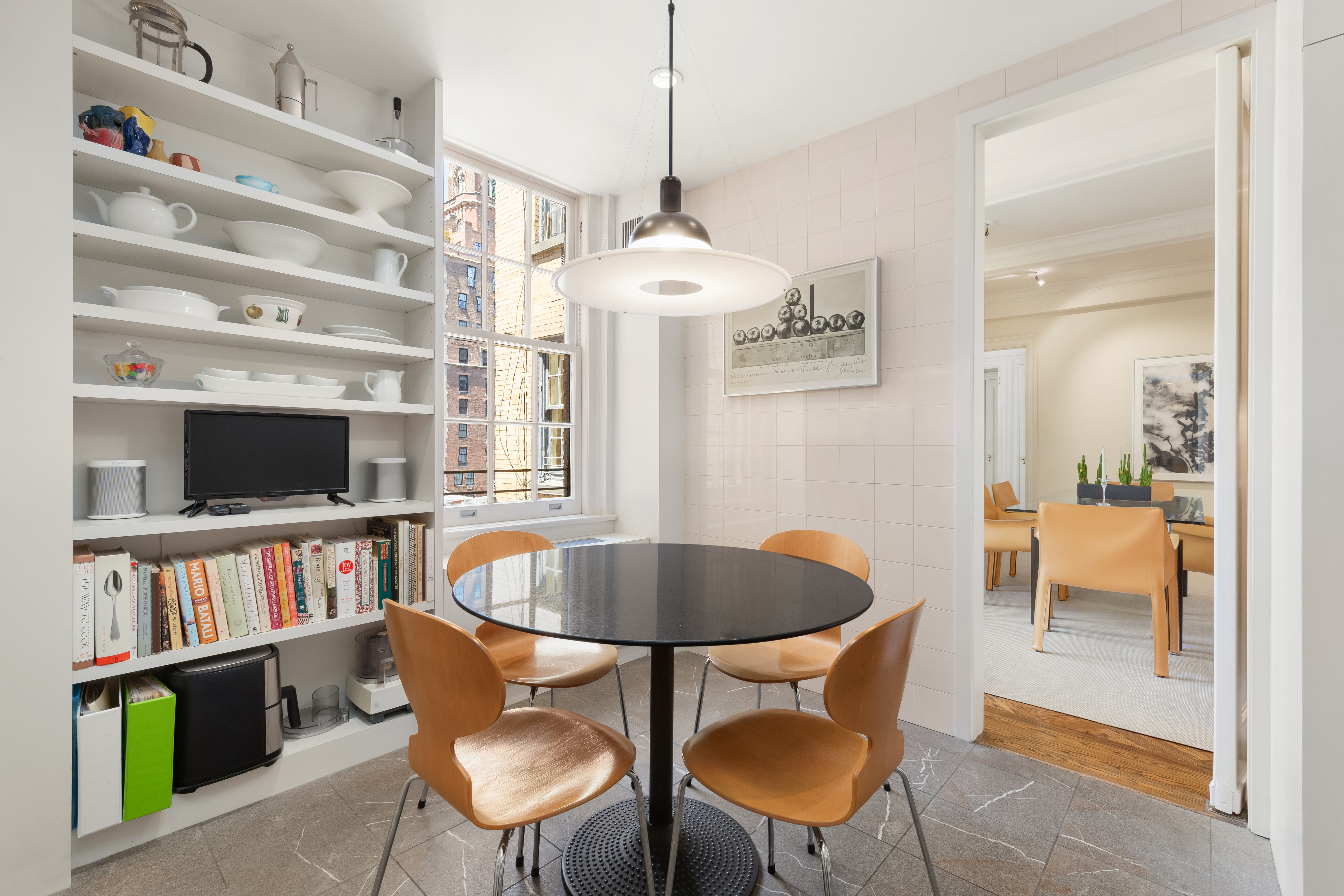 162 East 80th Street Manhattan, NY 10075 - Photo 5 of 13 a dining room with furniture and a flat screen tv