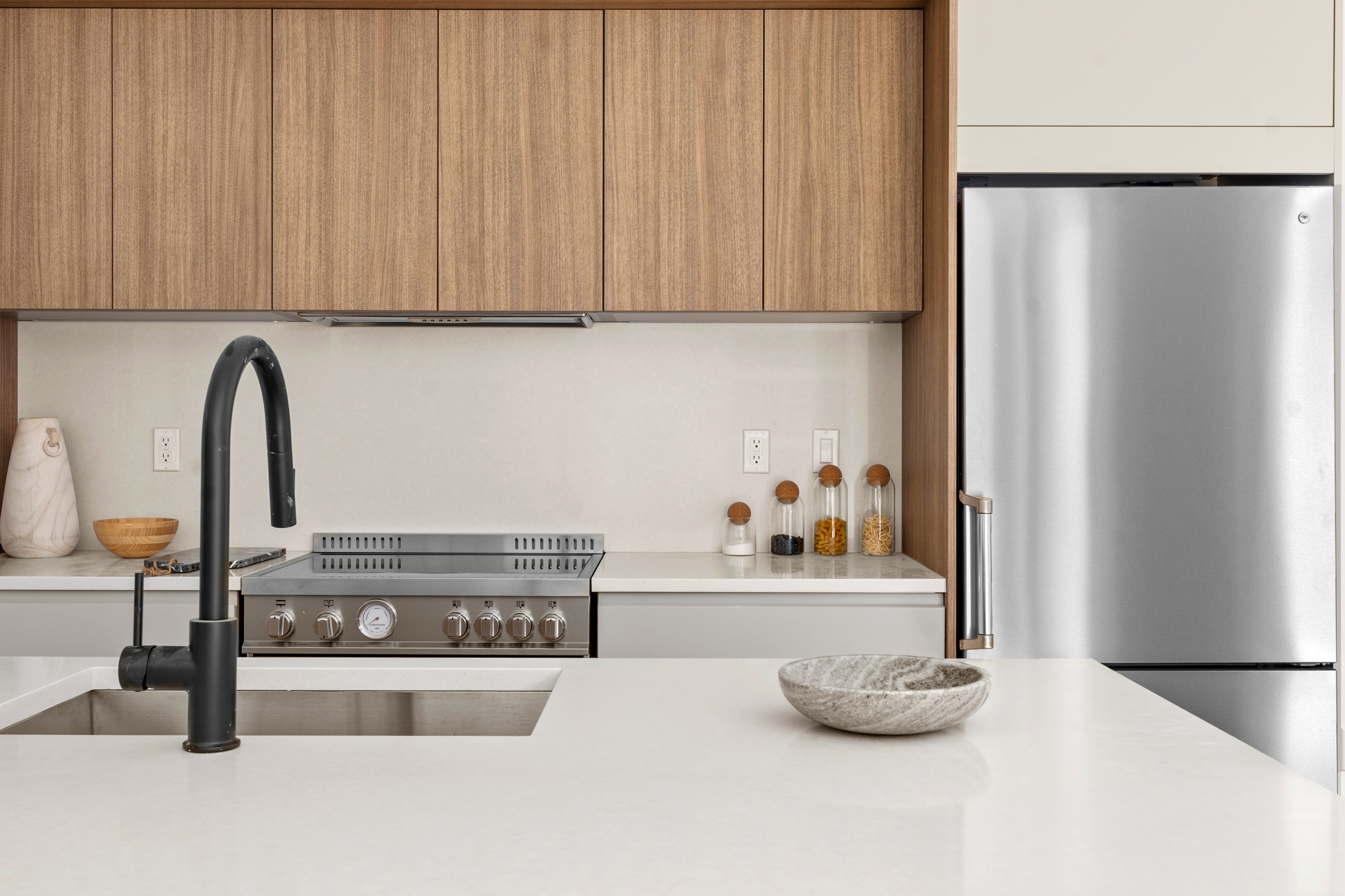 14-35 Broadway, Unit PH Queens, NY 11106 - Photo 4 of 24 a view of a kitchen with stainless steel appliances granite countertop a refrigerator and a stove