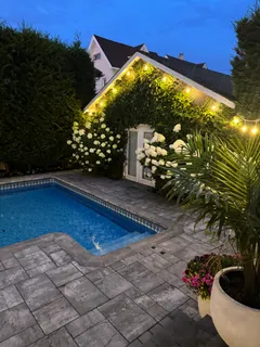 a view of a chairs and table in the backyard