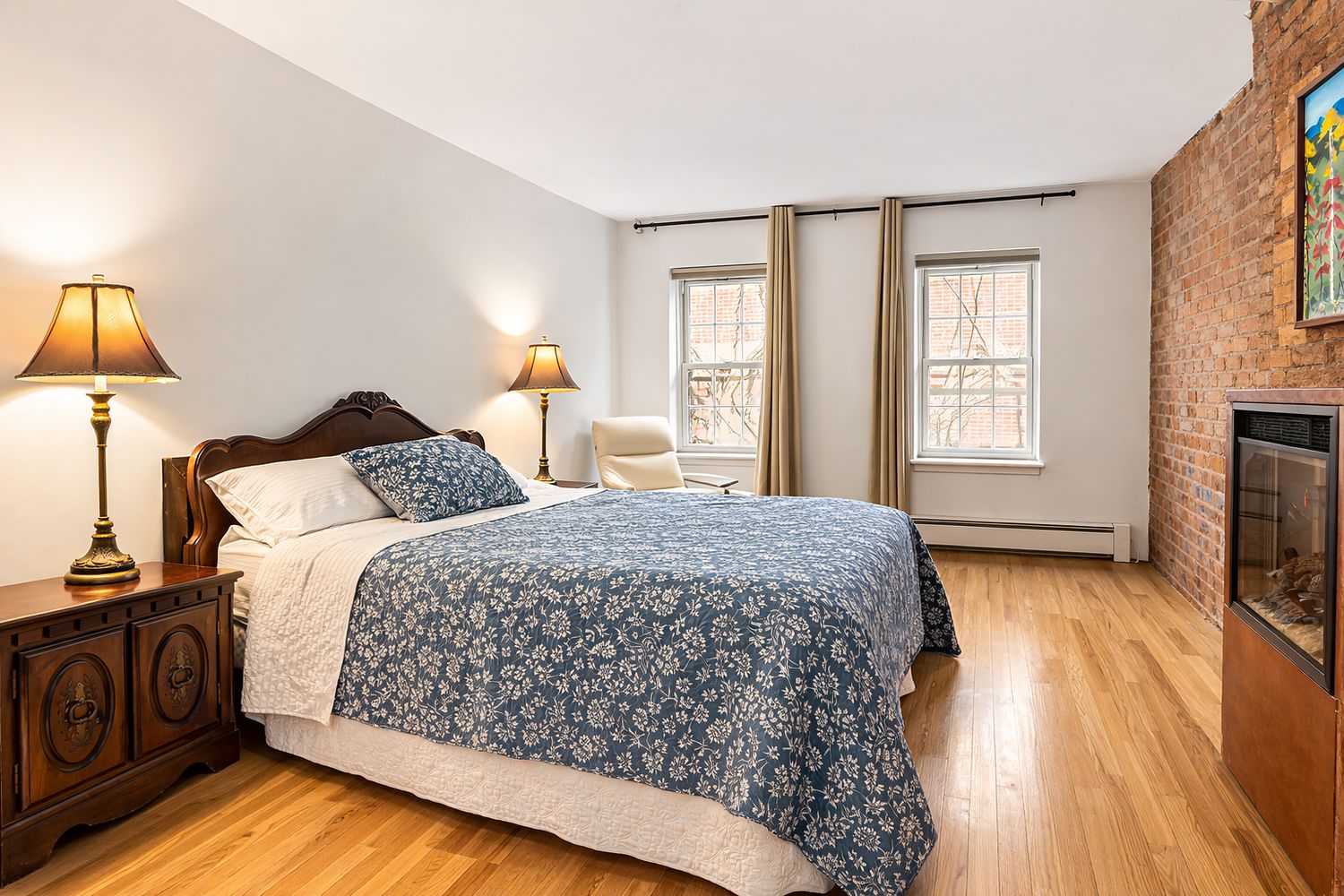 449 1/2 Hudson Street Manhattan, NY 10014 - Photo 12 of 19 a bedroom with a bed a fireplace and a window