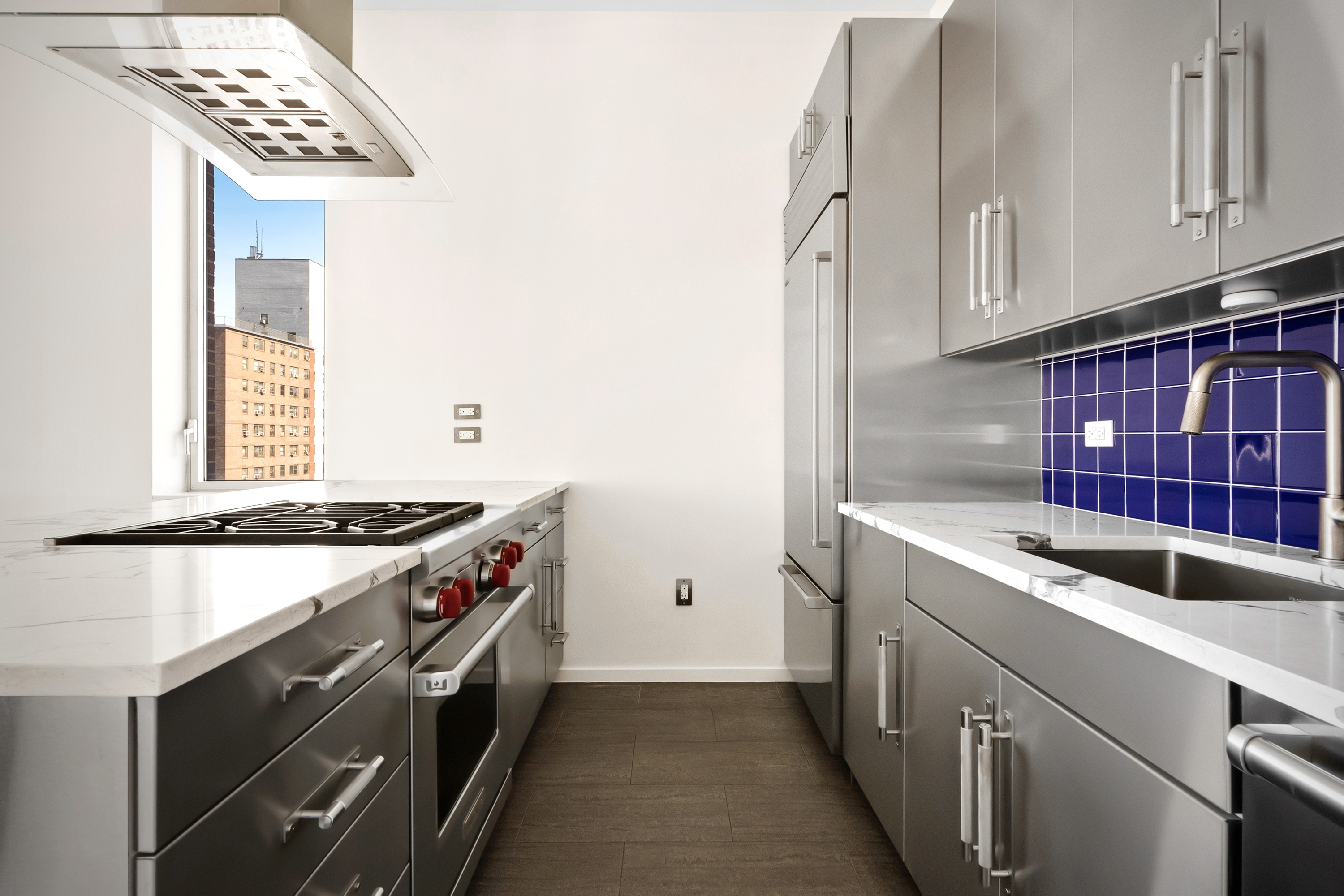 450 West 17th Street, Unit 2003 Manhattan, NY 10011 - Photo 4 of 7 a kitchen with stainless steel appliances granite countertop a stove and a sink