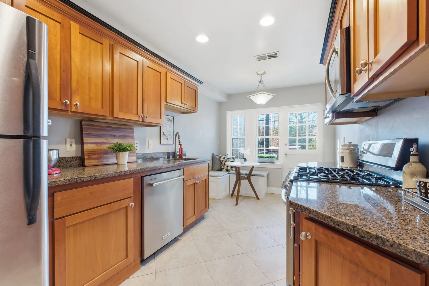 a kitchen with stainless steel appliances granite countertop sink stove and cabinets