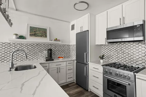 a kitchen with a stove and a refrigerator