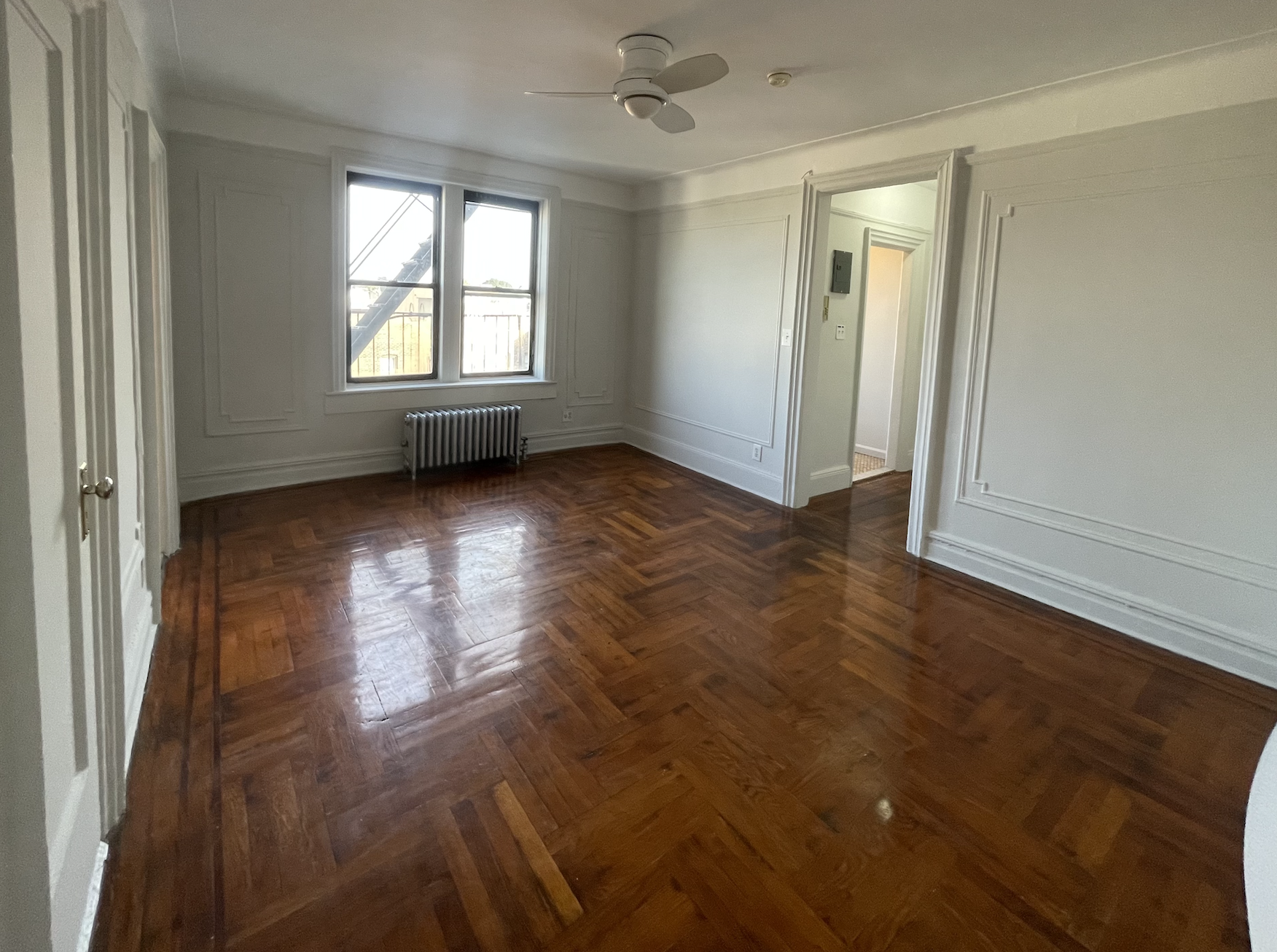 269 Prospect Place, Unit 6A Brooklyn, NY 11238 - Photo 3 of 6 an empty room with wooden floor and windows