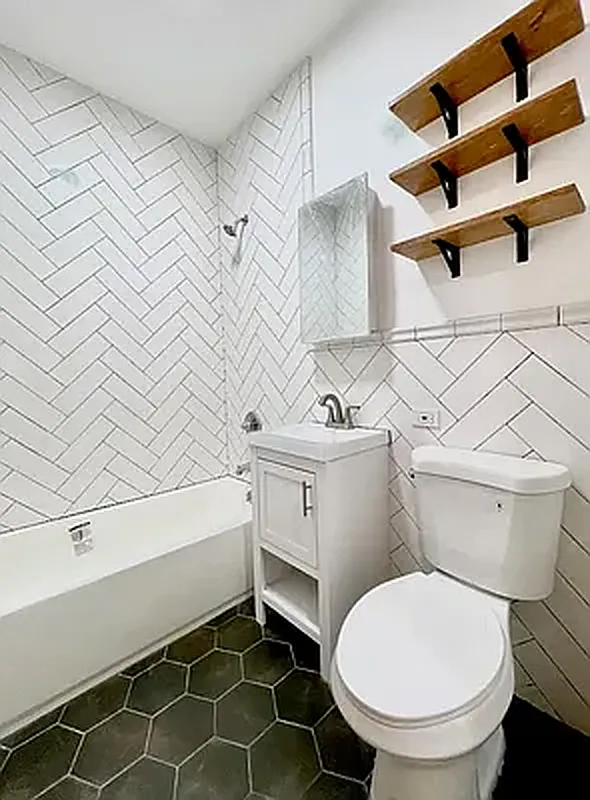 1120 Greene Avenue, Unit 1 Brooklyn, NY 11221 - Photo 12 of 13 a bathroom with a sink and a toilet