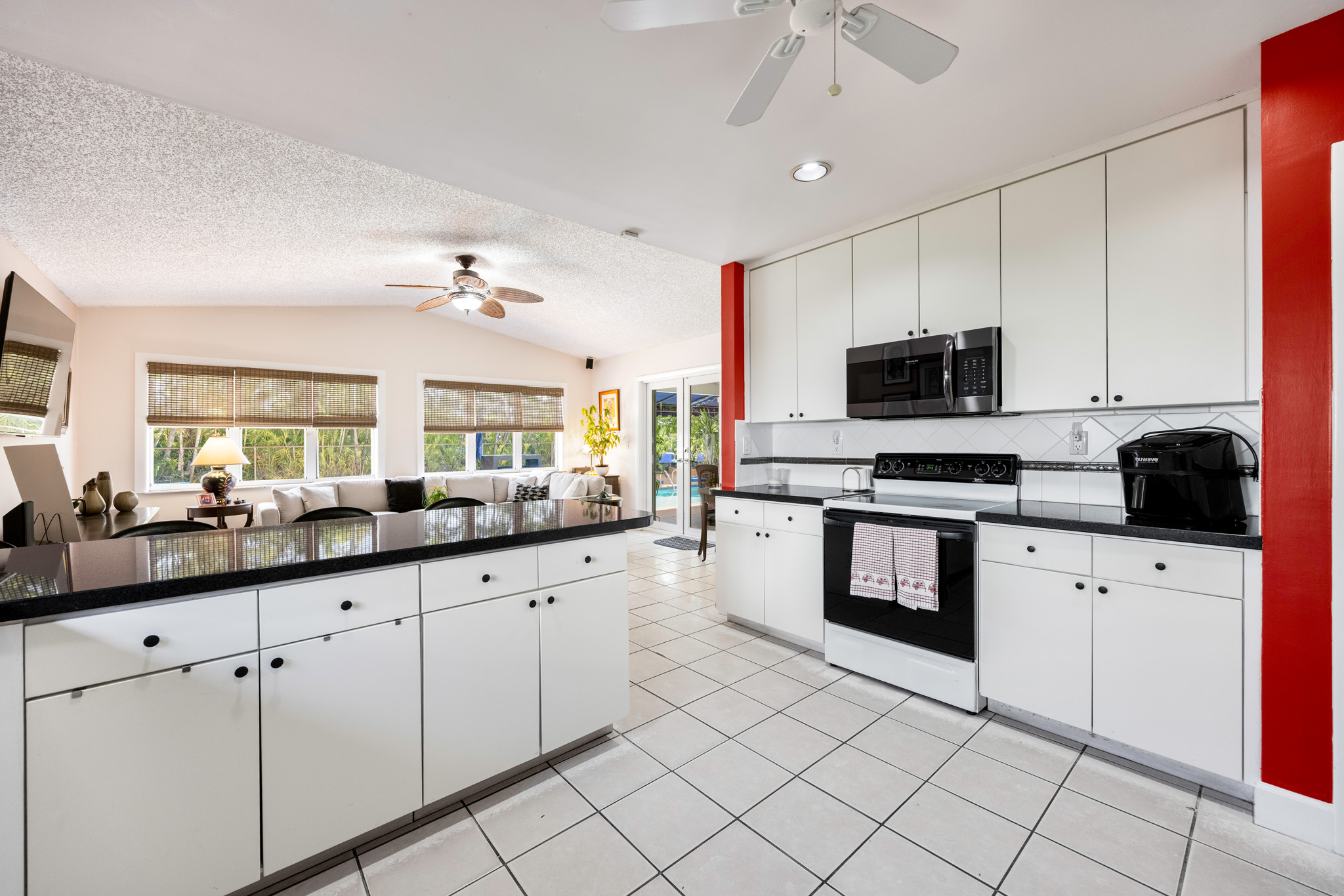 8610 Southwest 83rd Street Miami, FL 33143 - Photo 29 of 46 a kitchen with granite countertop a sink stainless steel appliances and cabinets