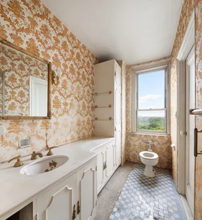 a bathroom with a double vanity sink toilet and a tub