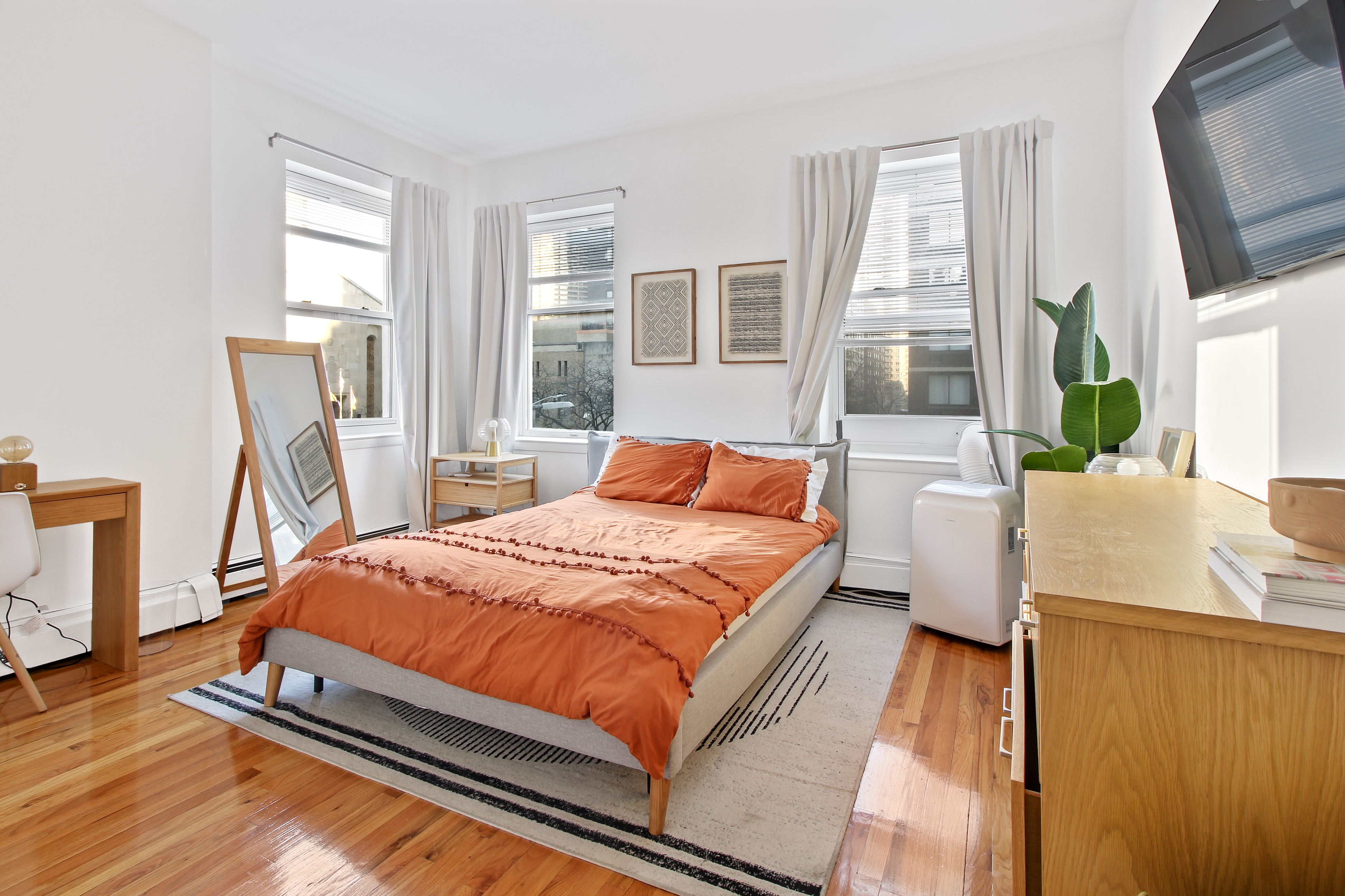 a bed sitting in a bedroom next to a window
